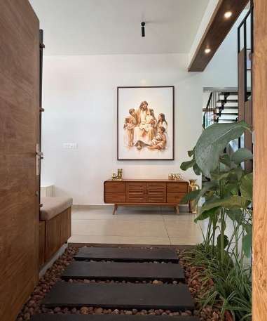 Entrance passage with stepping stones, pebbles and framed artwork
