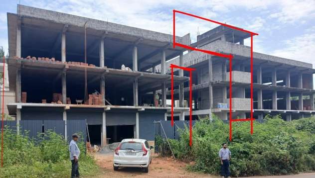 Existing concrete commercial building at Mambaram before remodelling, with proposed lines marked in red