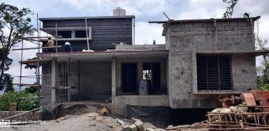 Valley Twin House under construction, showing the masonry shell